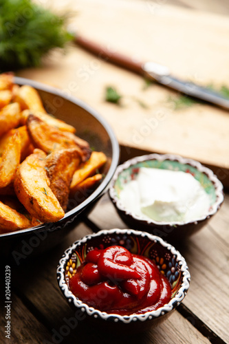 Baked potato fries on wooden table