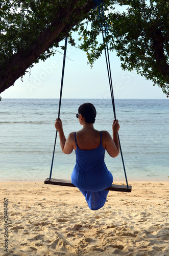 girl on the swing at the beach