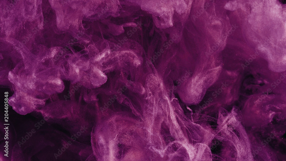 Ink in water. Colour pink glitter paint reacting in water creating abstract cloud formations.