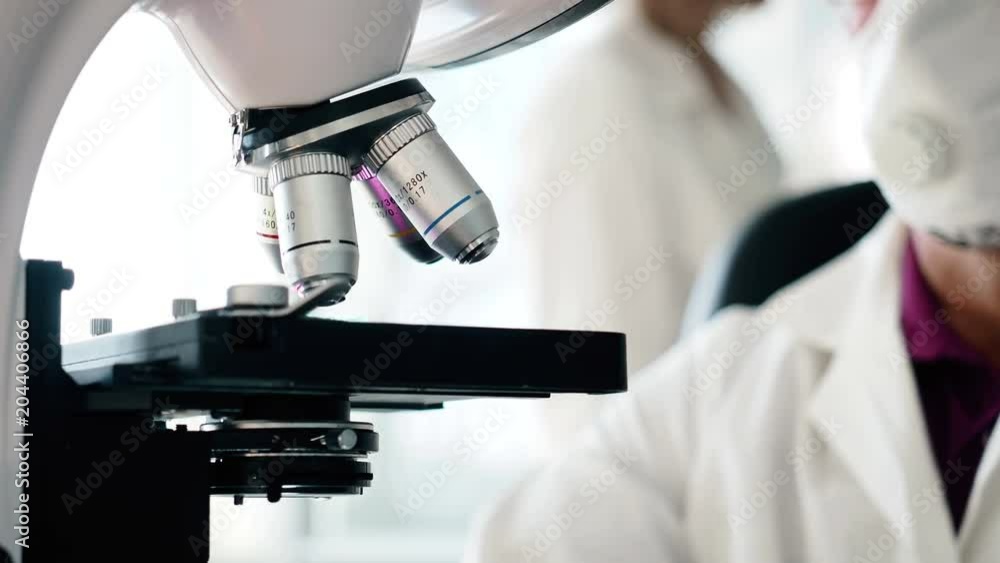 Concept of clinical expertise close up. Old male person discovery materials use the innovation microscope. Chemist tester work in laboratory, checking analysis of blood and create new vaccination Concept of clinical expertise close up. Old male person discovery materials use the innovation microscope. Chemist tester work in laboratory, checking analysis of blood and create new vaccination
