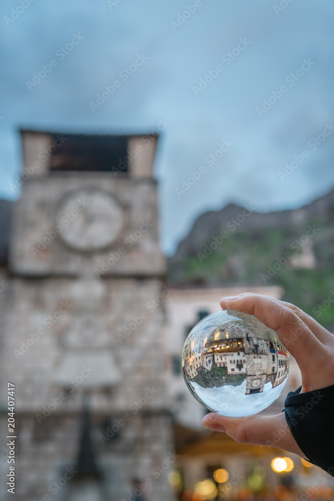 Naklejka premium Kotor clock tower in a glass ball