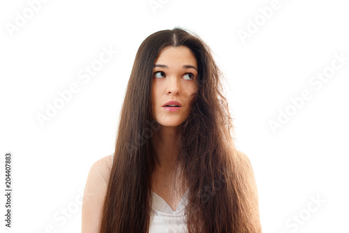 Young woman with well-groomed combed and problem unkempt hair. White background close up