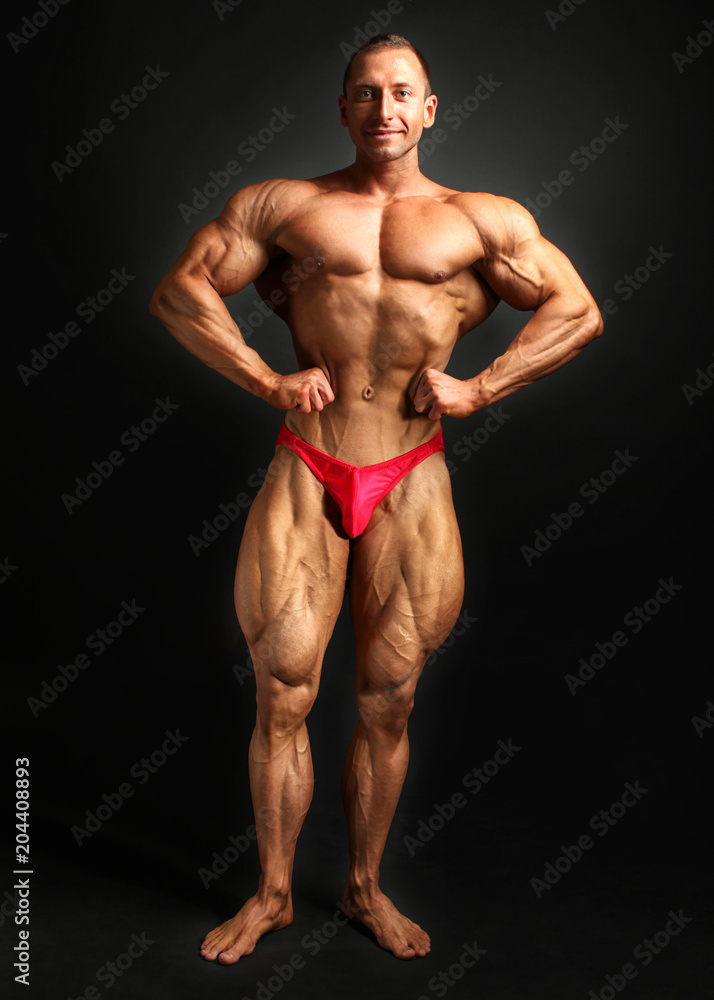 Studio shot of young male bodybuilder, posing, flexing his chest and legs muscles. Studio shot of young male bodybuilder, posing, flexing his chest and legs muscles.