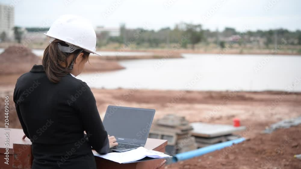 Engineer woman working at site of building under construction Engineer woman working at site of building under construction