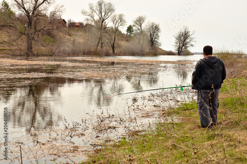 a man fishing on the Bank of the river 