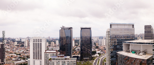 Aerial view of Sao Paulo with business buildings and houses on cloudy winter day.