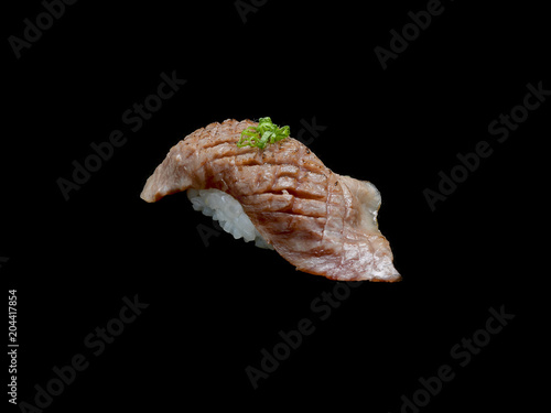 Matsusaka sushi is Japanese grill slide beef with Japanese rice with black isolated background .Matsusaka sushi is Japanese tradition meal. 