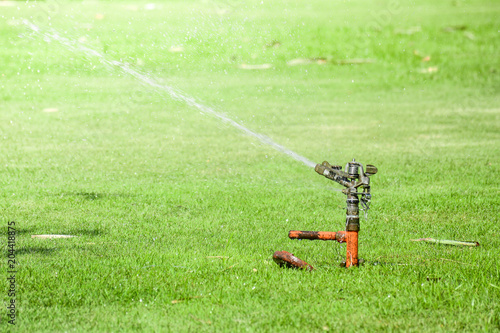 Lawn water sprinkler spraying a water