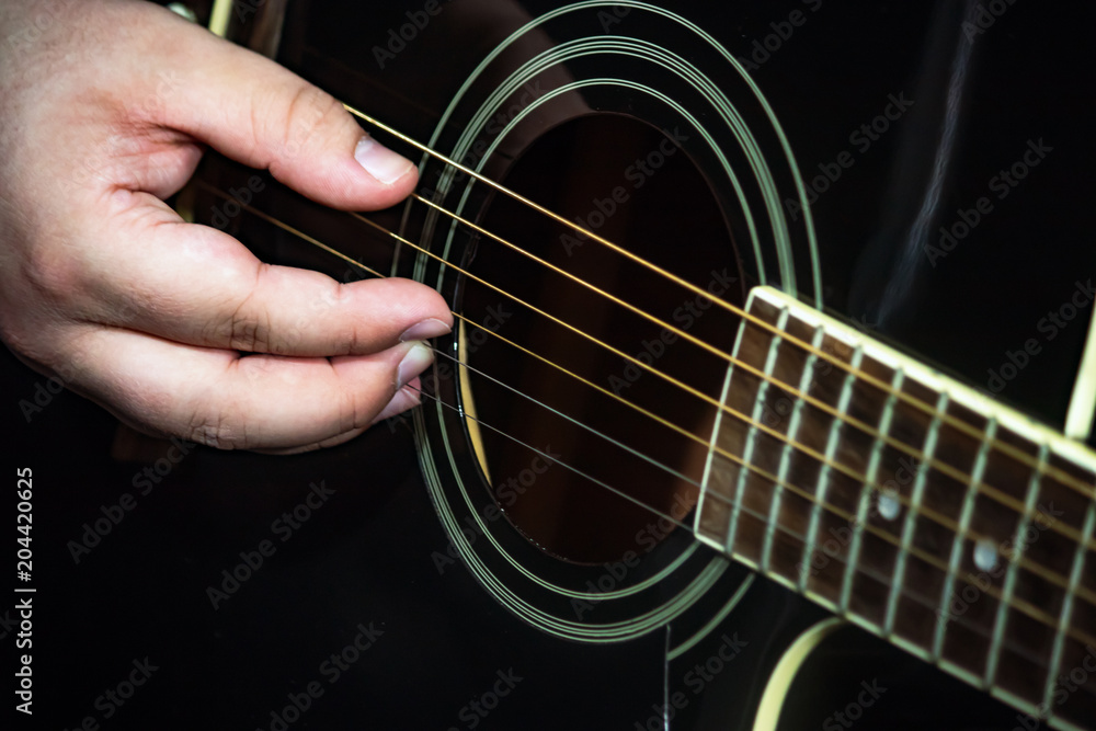 Fototapeta premium guitarist strumming acoustic guitar