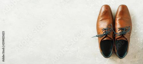 Top view of fashion male shoes on gray background. Sale and shopping concept. Copy space.