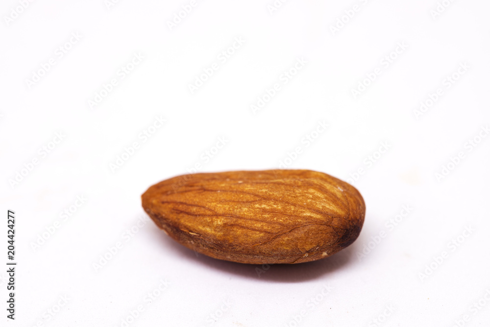 Ripe cleaned nut isolated on white background. Single almond closeup photo. Simple organic food. Ripe cleaned nut isolated on white background. Single almond closeup photo. Simple organic food.
