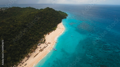 Aerial view of beautiful tropical island with with azure water, Boracay. Tropical lagoon with turquoise water. Beautiful tropical beach on the island. Seascape: Beautiful view of the rock in the sea