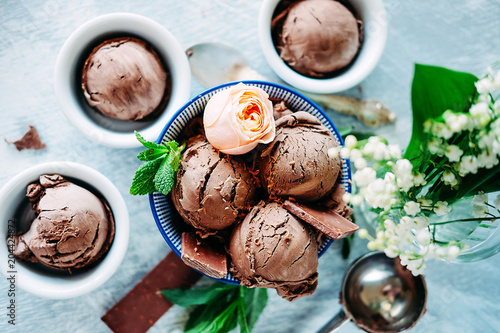Obraz na plátne Three scoops of dark chocolate ice cream sundae with sweet floral flavour