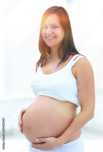 closeup of a pregnant woman putting her hands on her tummy. Free Download closeup of a pregnant woman putting her hands on her tummy. - GFXLoad
