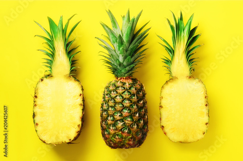 Bright pineapple pattern for minimal style. Top View. Pop art design, creative concept. Copy Space. Fresh pineapples on yellow background.