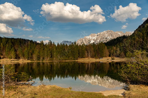 Reflections of the Kampenwand at Ferchensee and wood