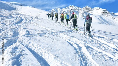 Group of touring skiers whit alpine guide reaching their goal