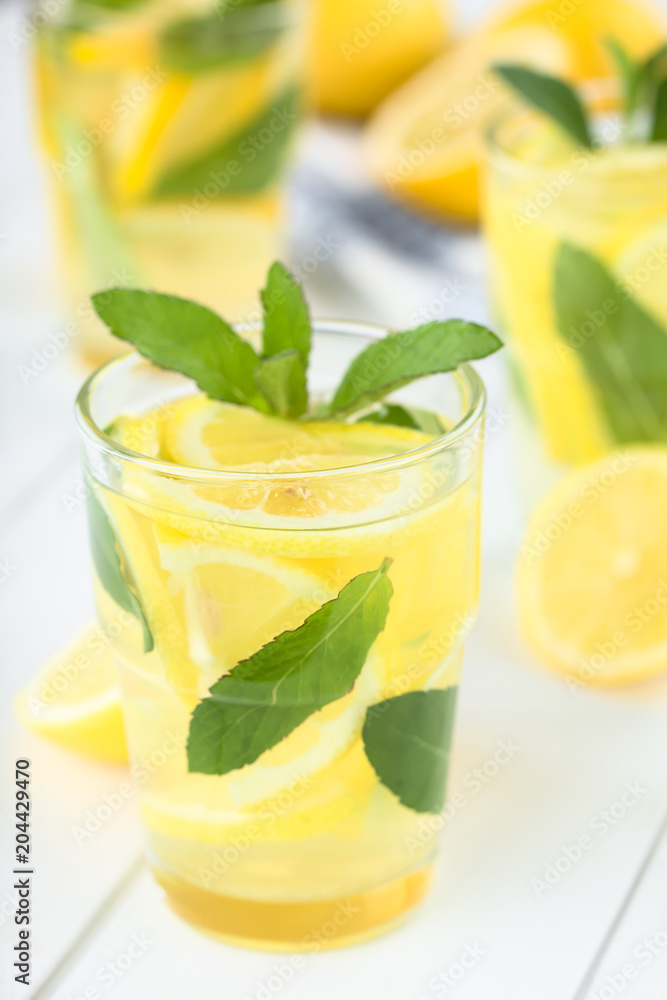 Fresh homemade lemonade with mint leaves (Selective Focus, Focus on the front of the rim of the first glass) Fresh homemade lemonade with mint leaves (Selective Focus, Focus on the front of the rim of the first glass)