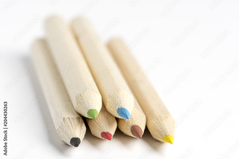 different colored crayons on white background different colored crayons on white background