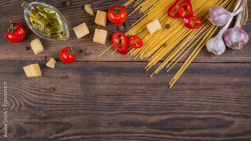 Ingredients for cooking spaghetti - raw pasta, tomato, olive oil, spices, herbs Ingredients for cooking spaghetti - raw pasta, tomato, olive oil, spices, herbs