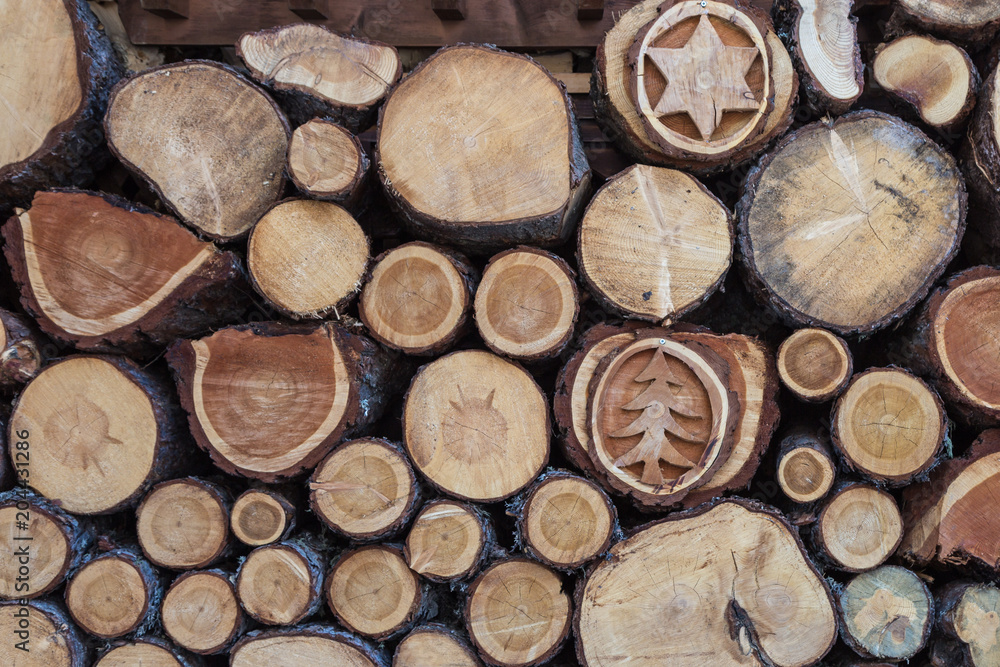 Woodpile with Beautiful Wood Decorations: Cross Section of Tree Trunks Background