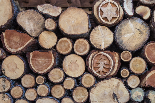 Woodpile with Beautiful Wood Decorations  Cross Section of Tree Trunks Background