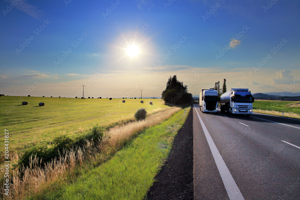 Truck transportation on the road at sunset Truck transportation on the road at sunset