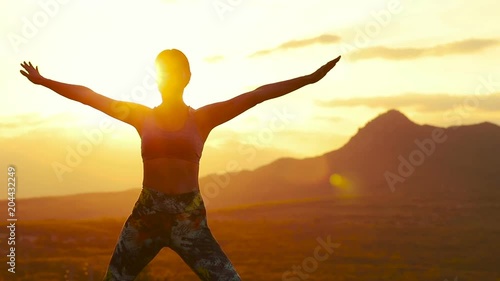 Woman doing yoga in the mountains. Slow motion