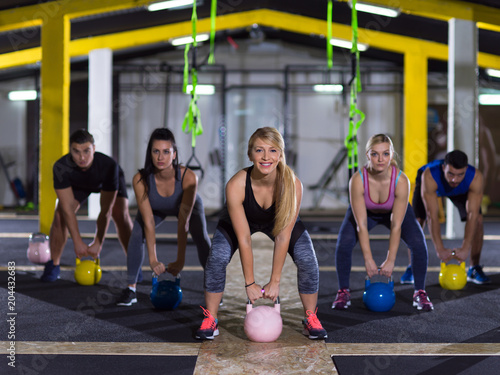 athletes doing exercises with kettlebells