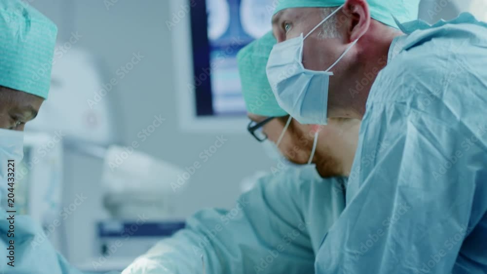 Diverse Team of Professional Surgeons Performing Invasive Surgery on a Patient in the Hospital Operating Room. Surgeons Use and other Instruments. Diverse Team of Professional Surgeons Performing Invasive Surgery on a Patient in the Hospital Operating Room. Surgeons Use and other Instruments.