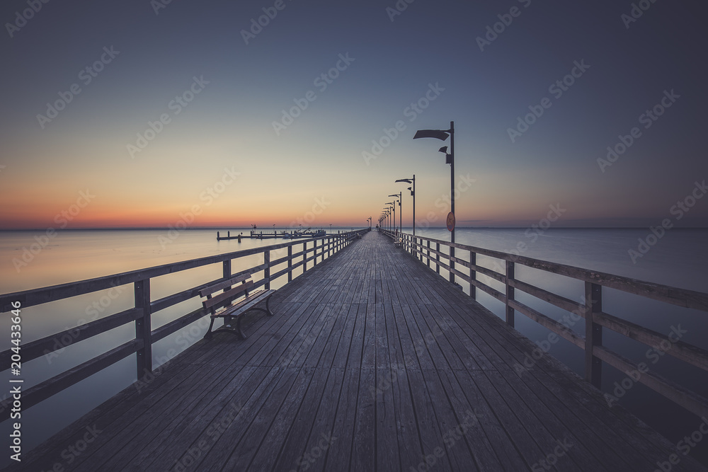 Wooden pier in Mechelinki. Small fishing village in Poland. Amazing Ssnrise at the beach