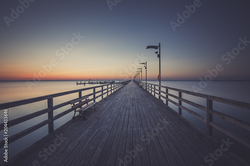 Fototapeta Naklejka Na Ścianę i Meble -  Wooden pier in Mechelinki. Small fishing village in Poland. Amazing Ssnrise at the beach
