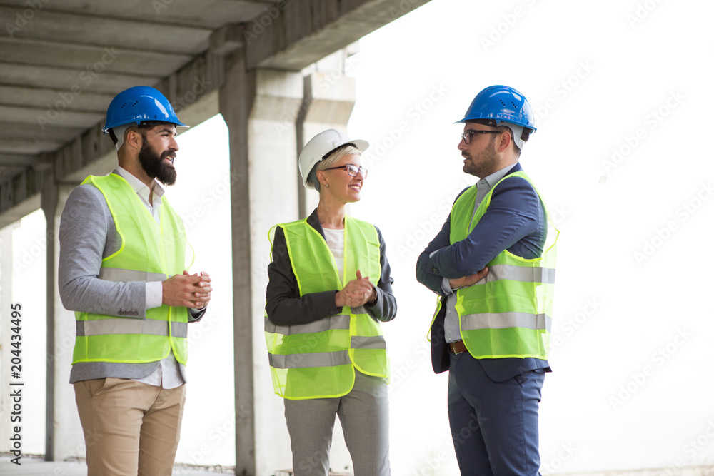 Engineers talk and plan construction on a construction site. Engineers talk and plan construction on a construction site.