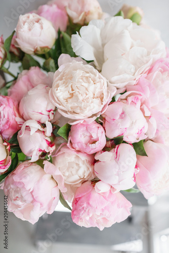 Lovely flowers in glass vase. Beautiful bouquet of white and pink peonies . Floral composition  daylight. Summer wallpaper. Pastel colors
