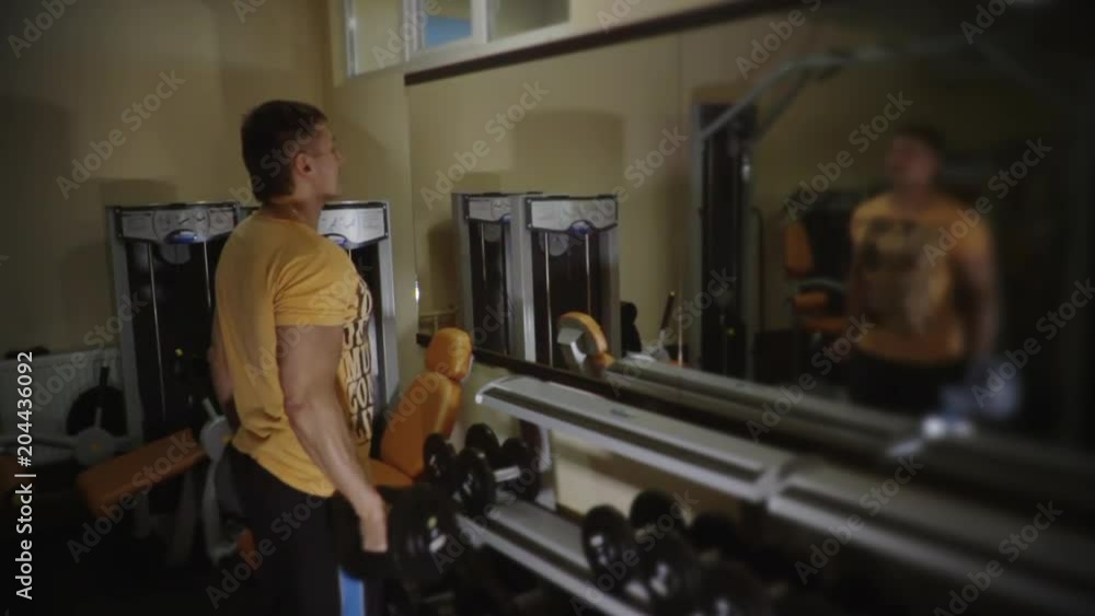Muscular middle age man doing exercise in gym 