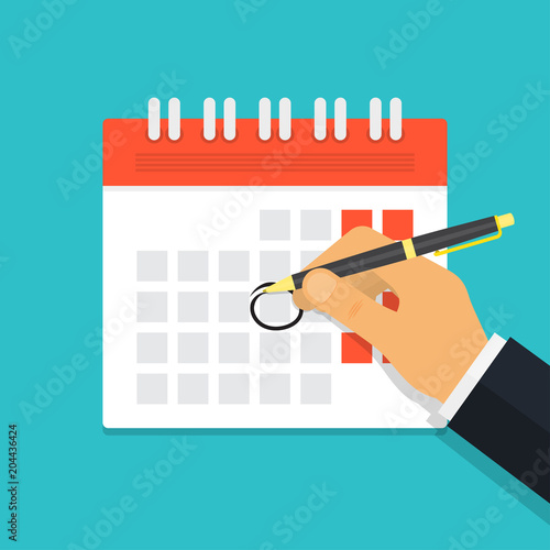 Hand with pen mark calendar
