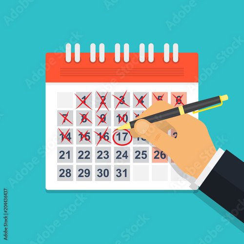 Hand with pen mark calendar