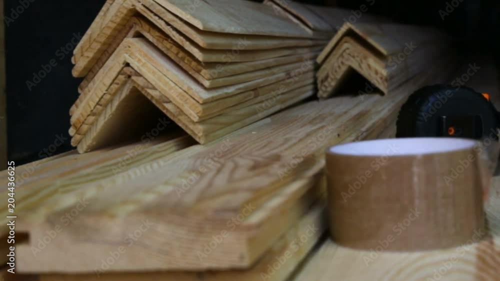 Building materials of wood corners and floor boards stockpiled on top