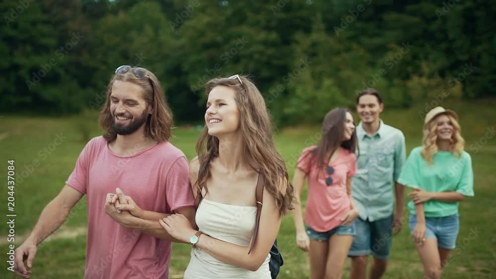 Friends Walking In Park. Happy Men And Women Having Fun Friends Walking In Park. Happy Men And Women Having Fun
