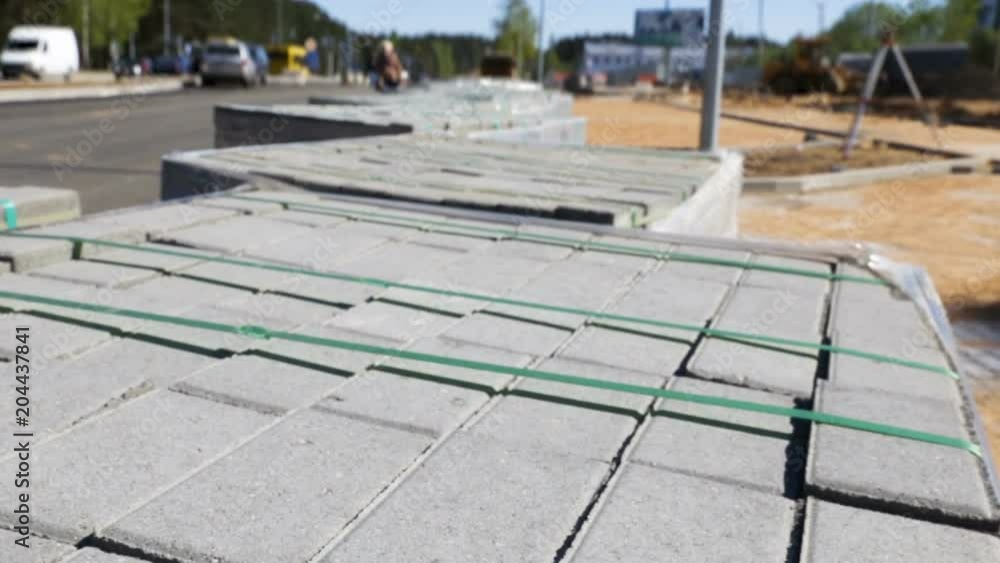 the sidewalk tiles on the pallet, wrapping film and rope. Outdoor ...