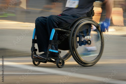 Racing in a Wheelchair. Competitor using a wheelchair in a race. Motion blur.