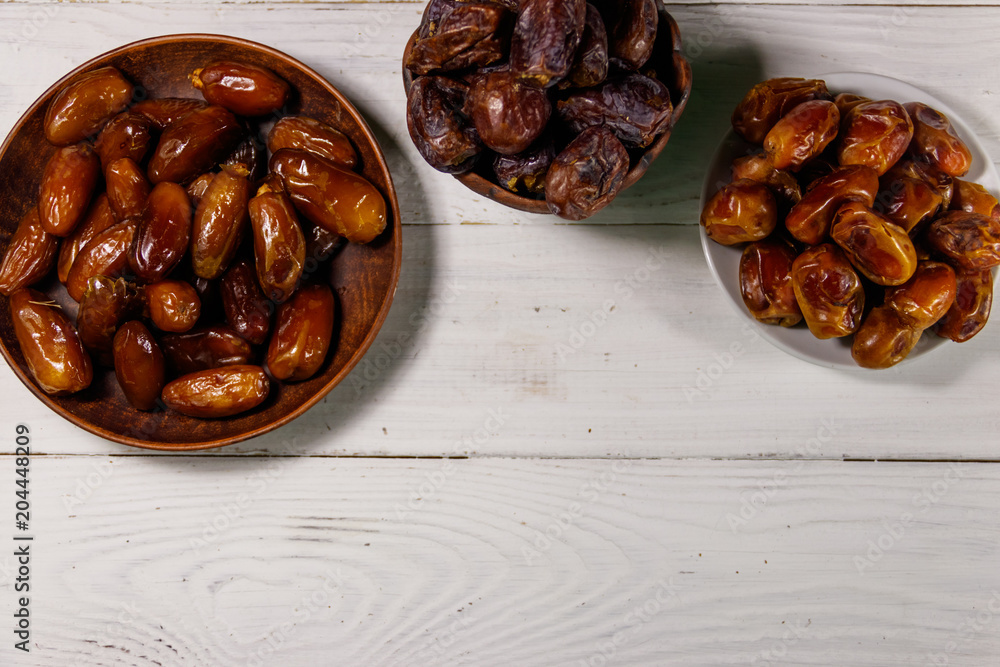 Dried dates fruit on white wooden table. Top view Dried dates fruit on white wooden table. Top view