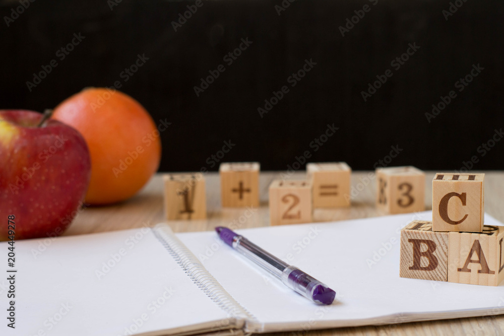 apple and cubes with letters on a black background