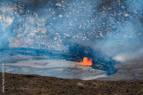 Lava lake in the active Kilauea volcano with bubbling hot lava and smoke, Big Island, Hawaii 