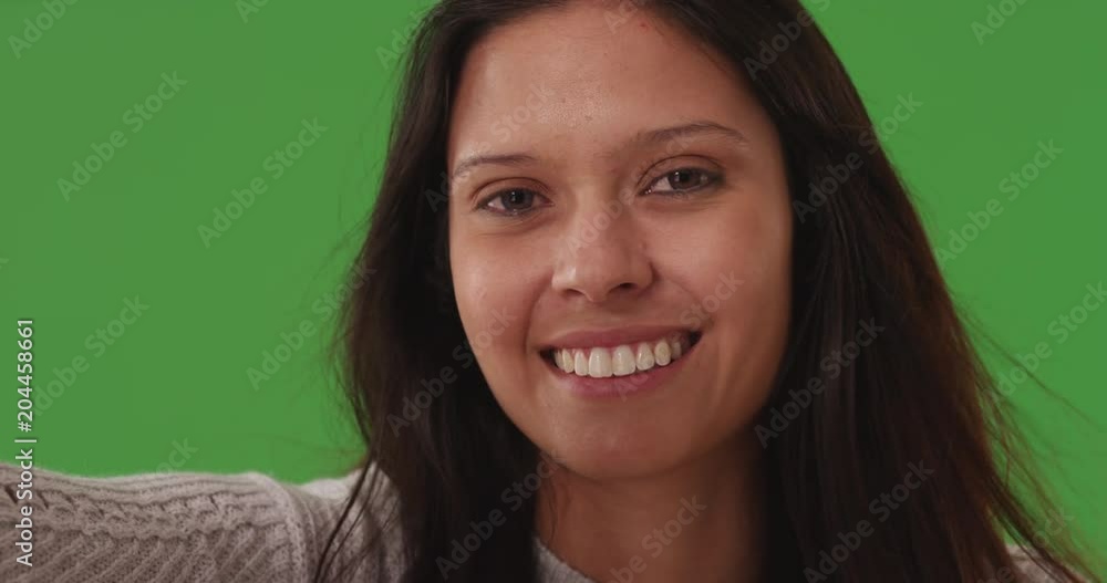 Close up portrait of attractive young lady smiling at camera on green screen Close up portrait of attractive young lady smiling at camera on green screen