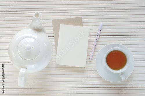 Morning tea flat lay.tea with blank notebook on a light wooden background. top view, copy space