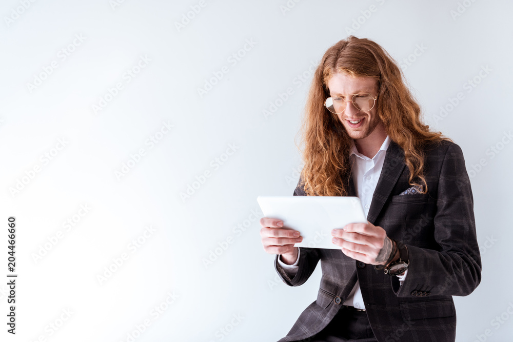 stylish businessman with curly hair using tablet isolated on white stylish businessman with curly hair using tablet isolated on white