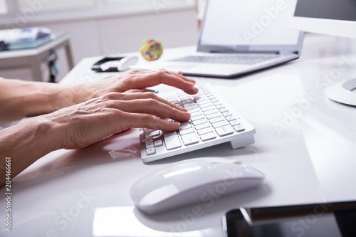 Businessperson Typing On Computer Keyboard