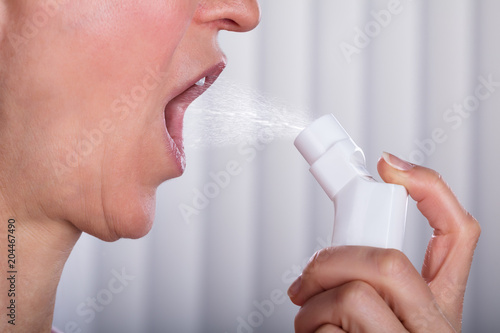 Woman Using Asthma Inhaler
