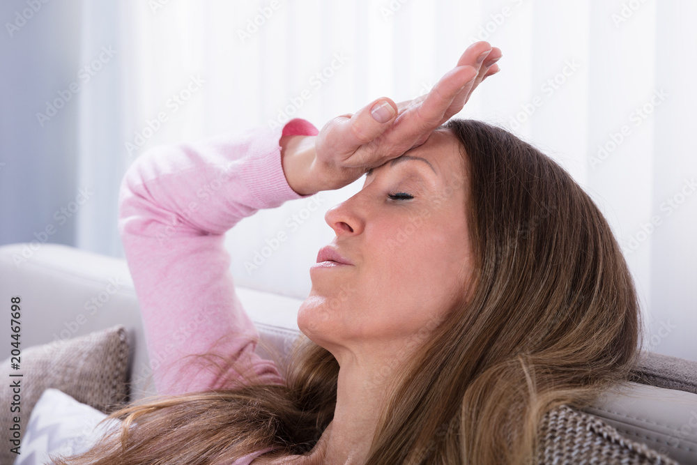 Fototapeta premium Exhausted Woman Relaxing On Sofa